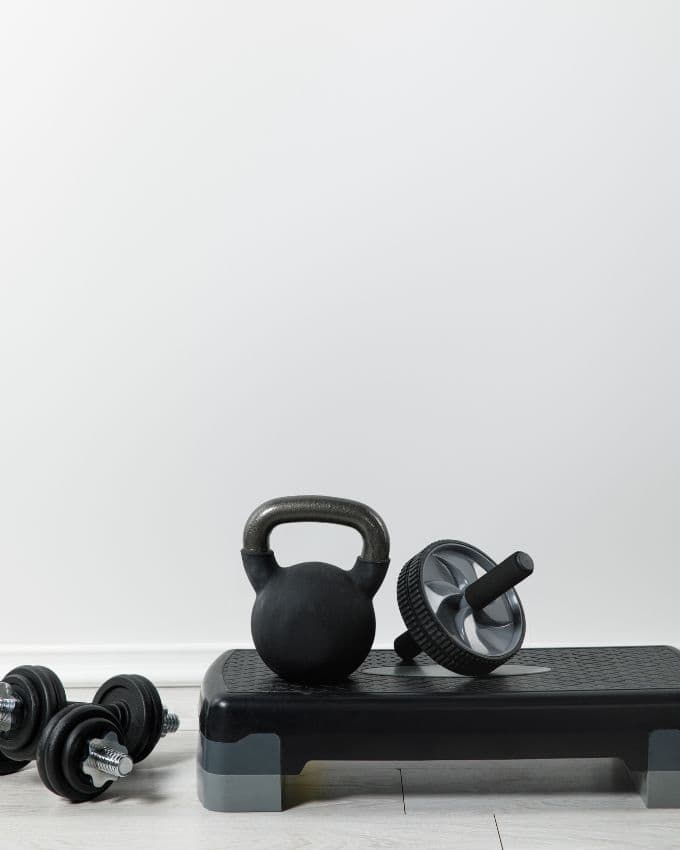 Ein Set Kurzhanteln, eine Kettlebell und eine Stepbank.